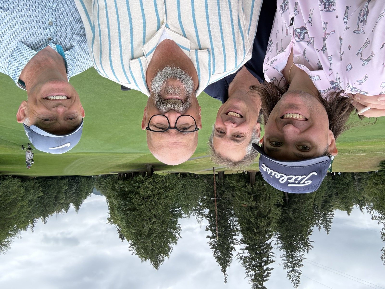 The foursome on an evergreen-lined course