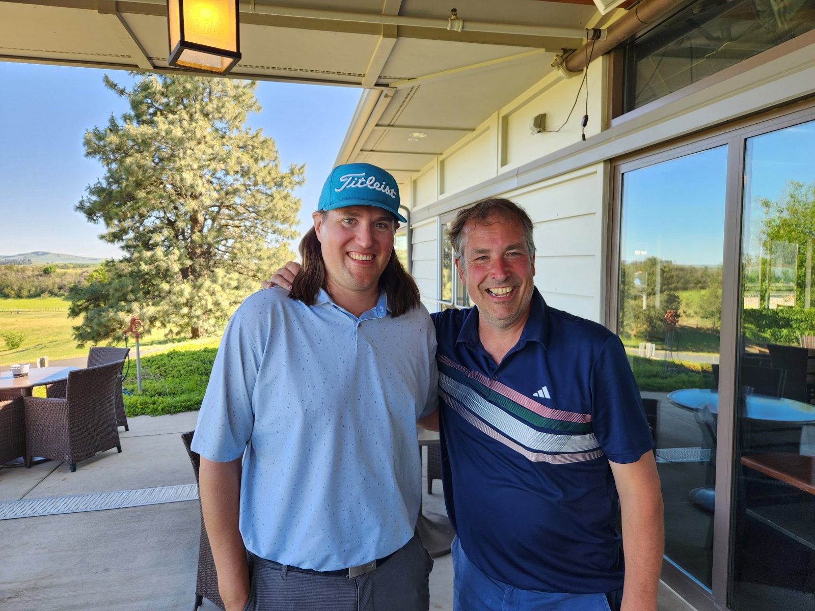 Two members on the clubhouse patio